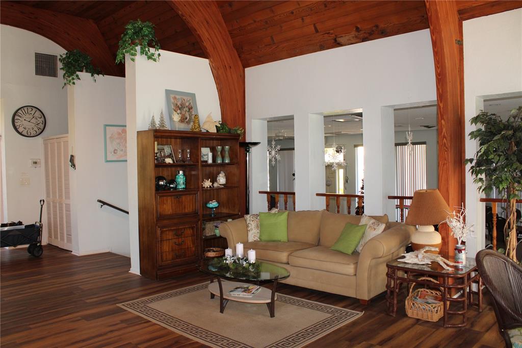 11485 Oakhurst Road, Unit 1200215 Largo, FL 33774 - Photo 42 of 68 a living room with furniture a rug and white walls
