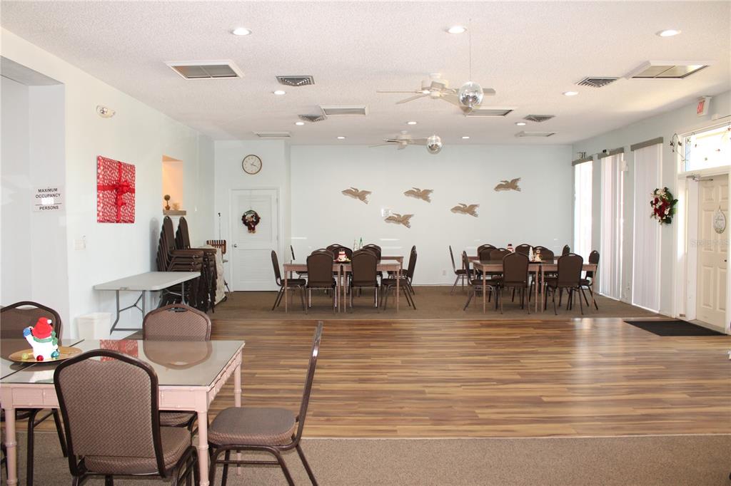 11485 Oakhurst Road, Unit 1200215 Largo, FL 33774 - Photo 43 of 68 a view of a dining room with furniture