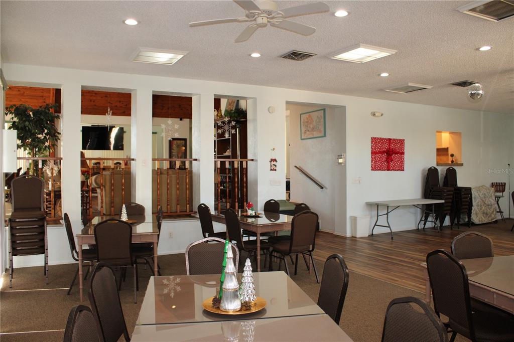 11485 Oakhurst Road, Unit 1200215 Largo, FL 33774 - Photo 44 of 68 a living room with furniture kitchen view and a chandelier