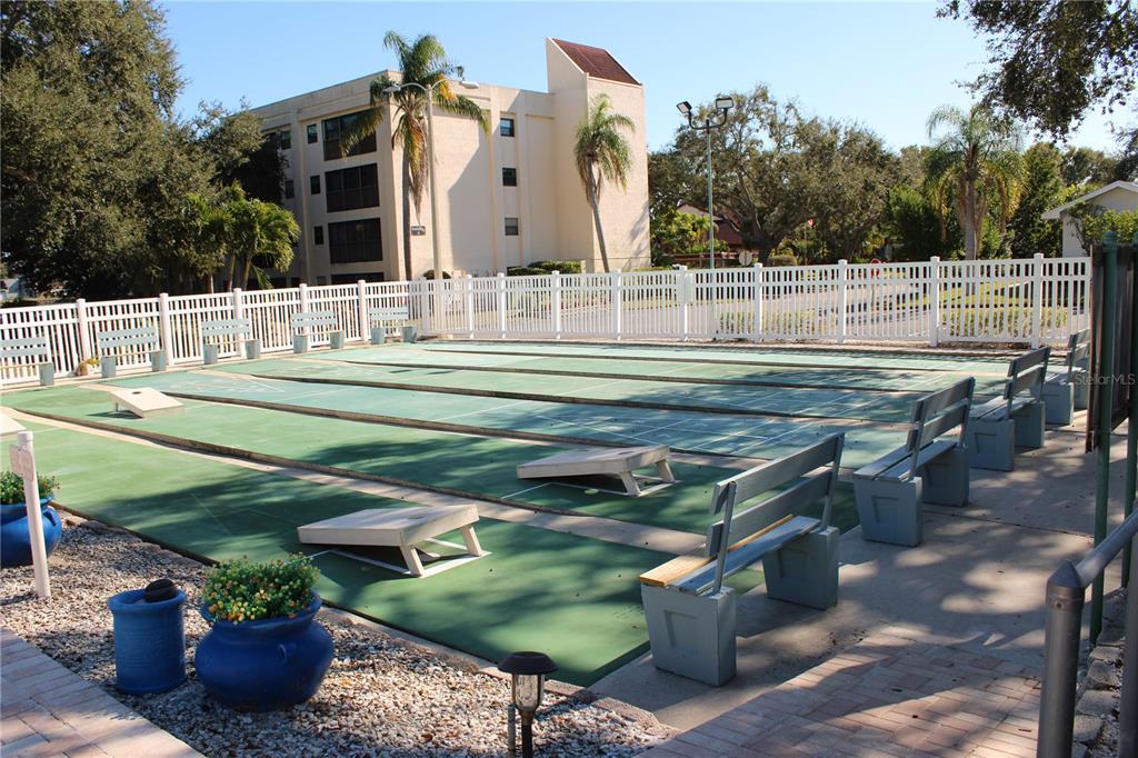 11485 Oakhurst Road, Unit 1200215 Largo, FL 33774 - Photo 54 of 68 a view of a chairs and table in the back yard of the house