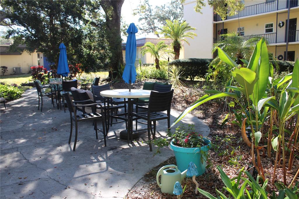 11485 Oakhurst Road, Unit 1200215 Largo, FL 33774 - Photo 57 of 68 a view of a tables and chairs in a patio