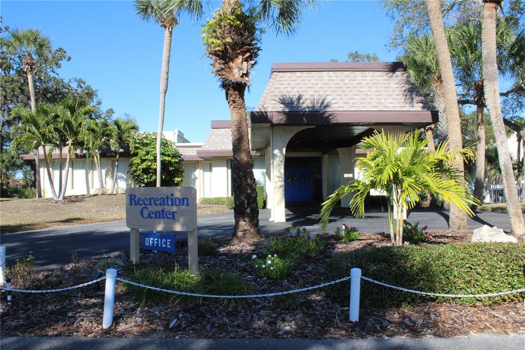 11485 Oakhurst Road, Unit 1200215 Largo, FL 33774 - Photo 65 of 68 a front view of a house with garden