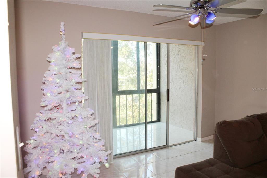 11485 Oakhurst Road, Unit 1200215 Largo, FL 33774 - Photo 7 of 68 a living room with furniture and a large window
