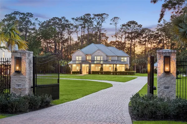 a kitchen with stainless steel appliances granite countertop a stove a sink a refrigerator and a dining table