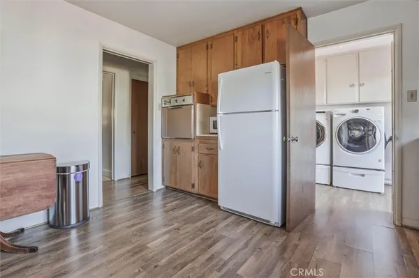 a view of a refrigerator in kitchen and wooden floor