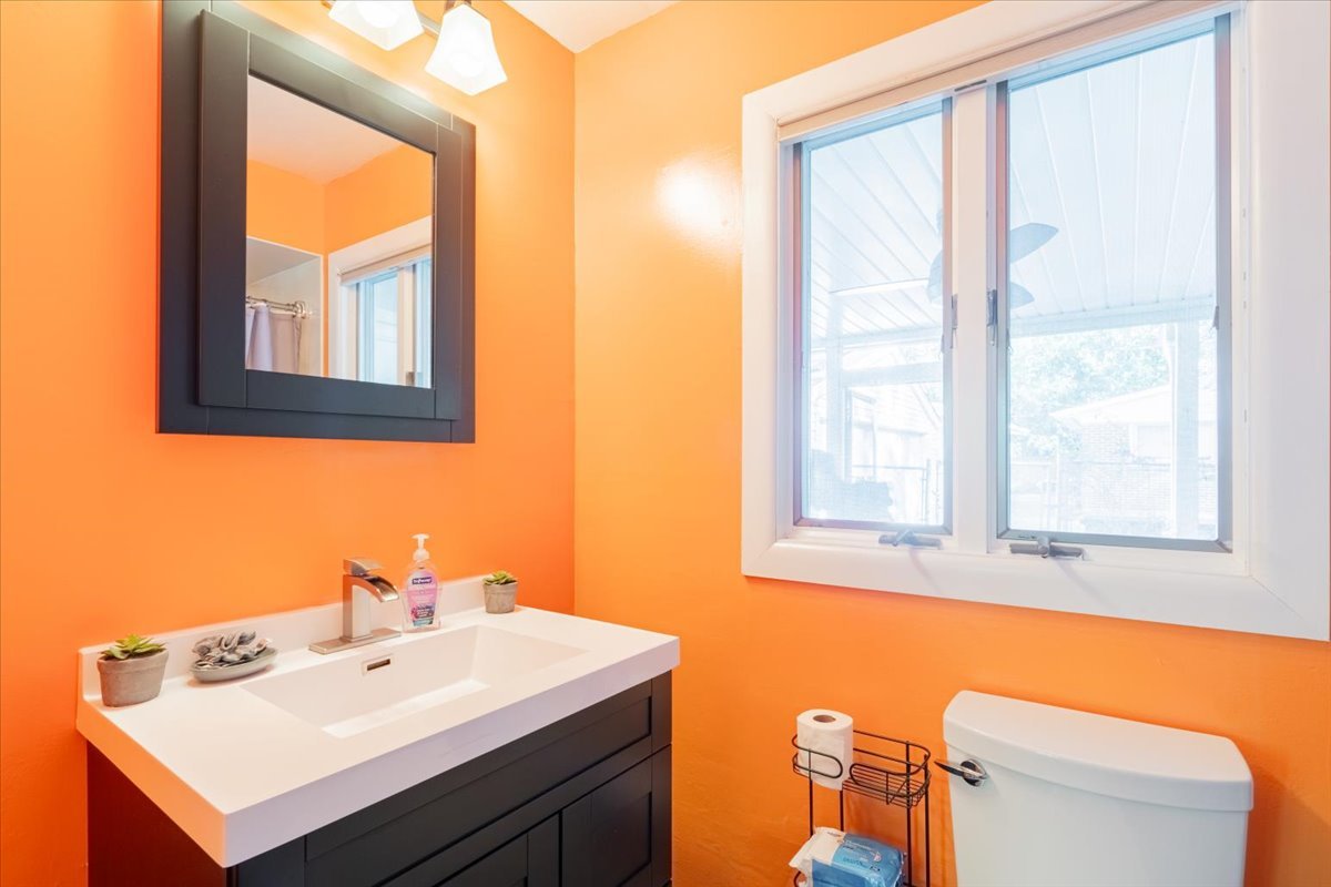 310 Rowe Drive Bloomington, IL 61701 - Photo 17 of 39 a bathroom with a sink a mirror and a window