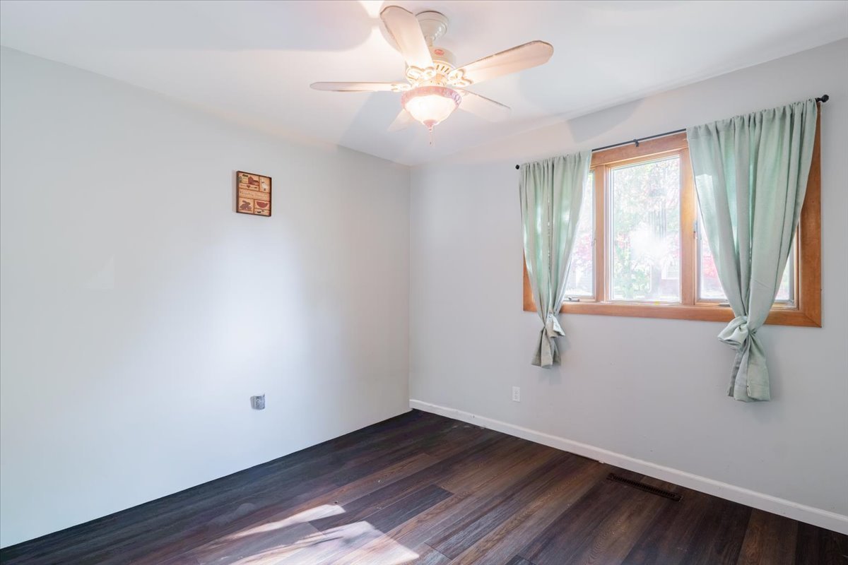 310 Rowe Drive Bloomington, IL 61701 - Photo 23 of 39 wooden floor in an empty room with a window