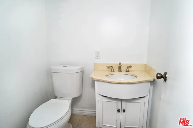 a bathroom with a toilet a sink and a mirror