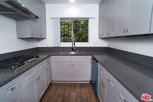 a kitchen with a sink stove and cabinets