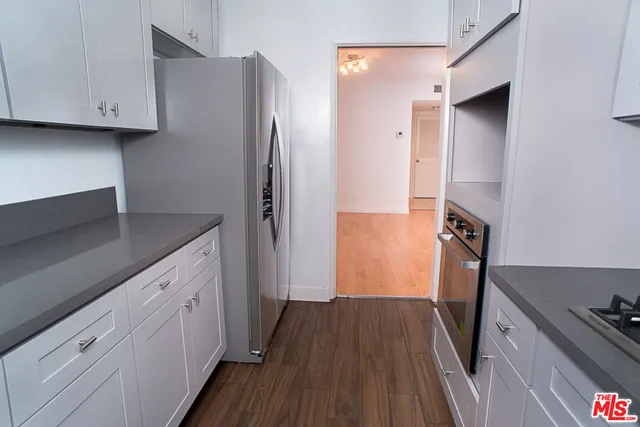 a kitchen with a refrigerator and a stove
