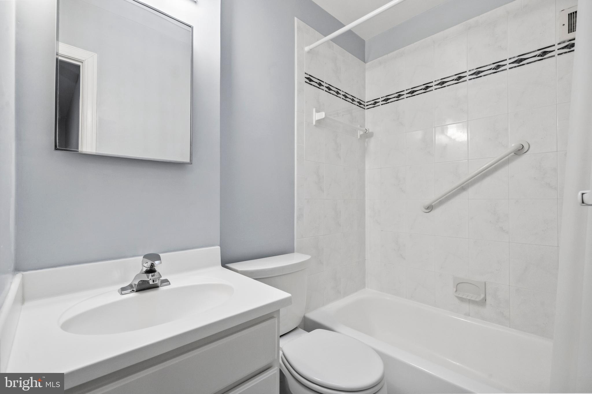4228 40th Street Northwest Washington, DC 20016 - Photo 21 of 57 a bathroom with a sink mirror and a toilet
