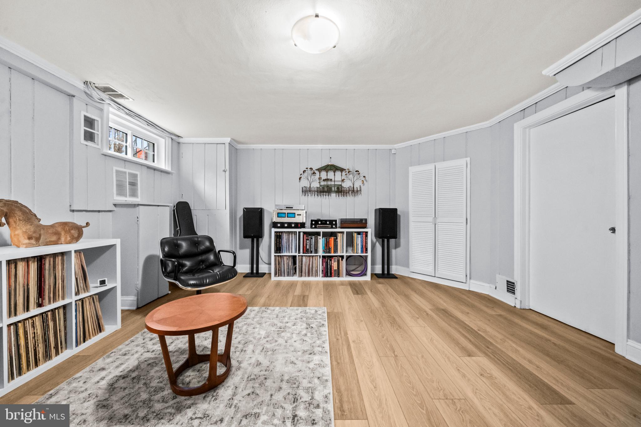 4228 40th Street Northwest Washington, DC 20016 - Photo 28 of 57 a living room with furniture a rug and a book shelf