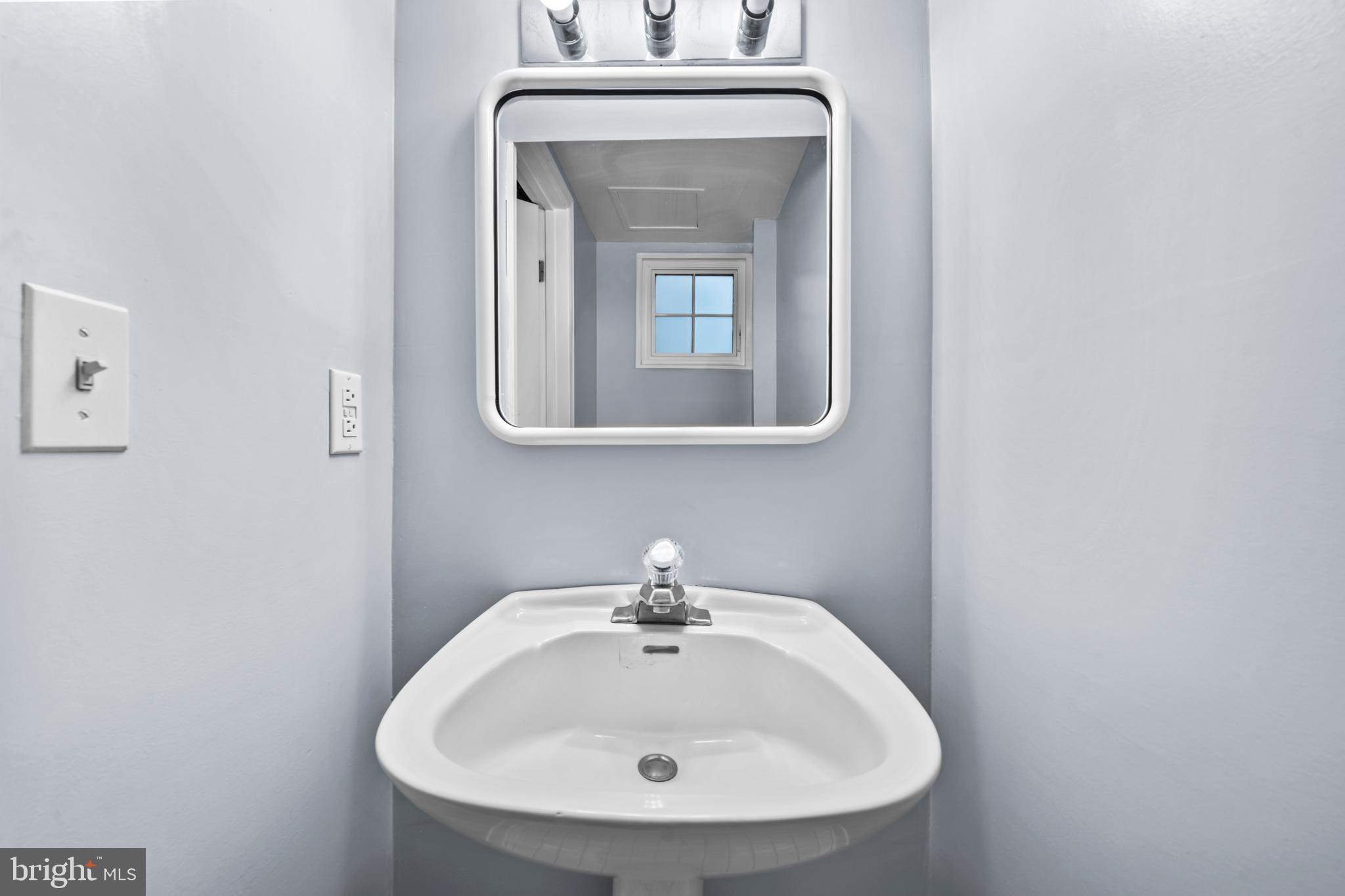 4228 40th Street Northwest Washington, DC 20016 - Photo 33 of 57 a bathroom with a sink and a mirror