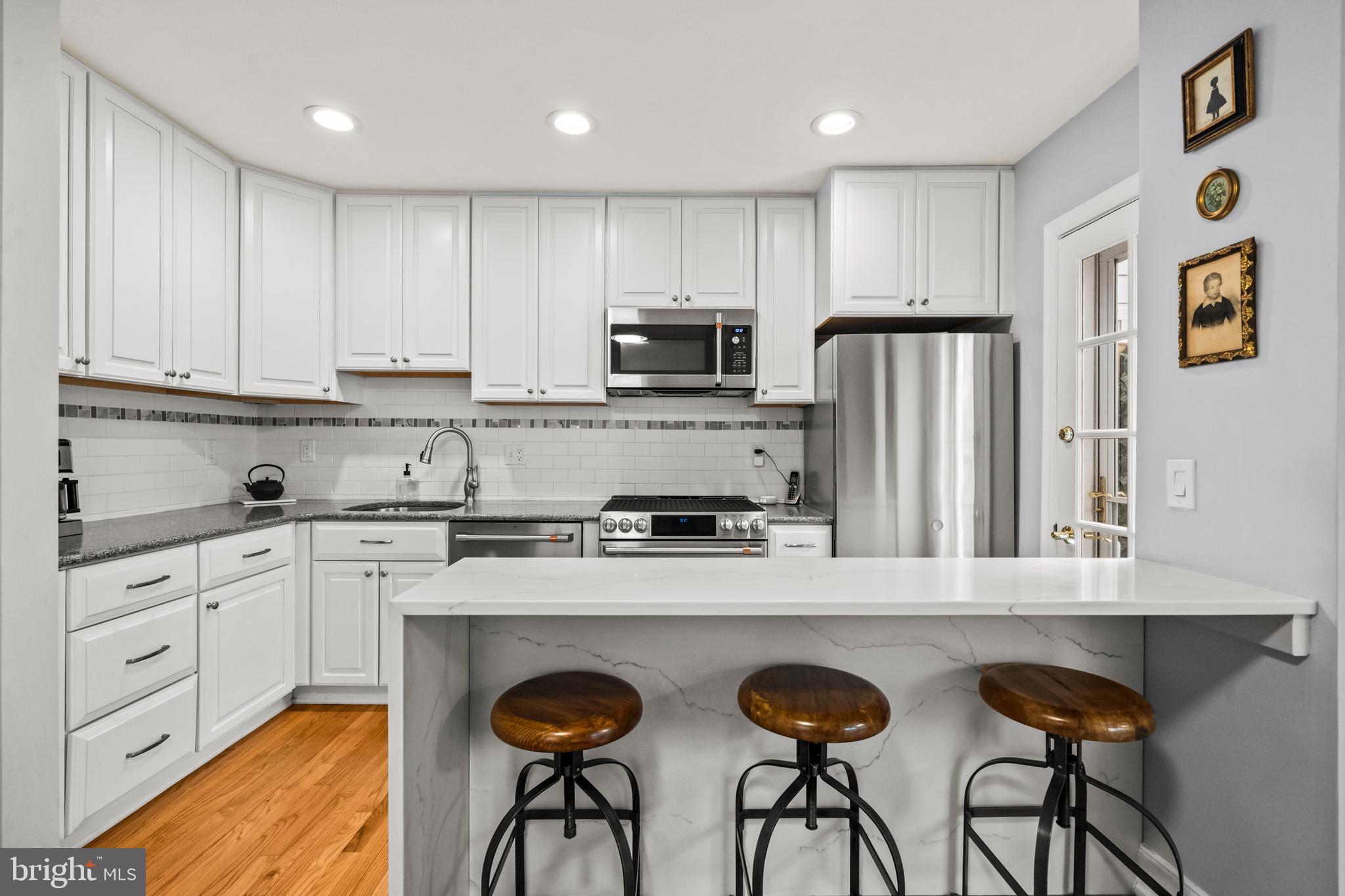 4228 40th Street Northwest Washington, DC 20016 - Photo 10 of 57 a kitchen with granite countertop a refrigerator and a stove top oven