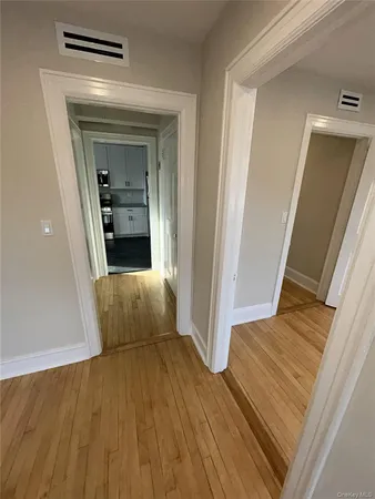 a view of a hallway view with wooden floor and staircase