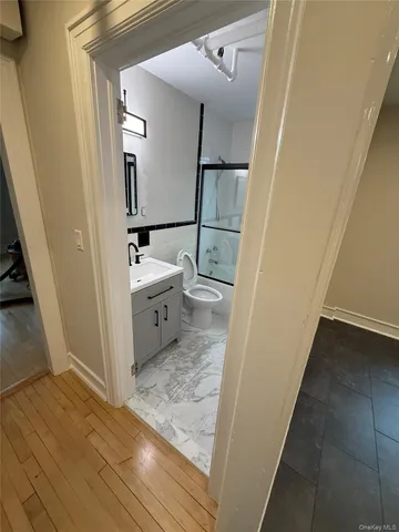 a bathroom with a sink a toilet and shower