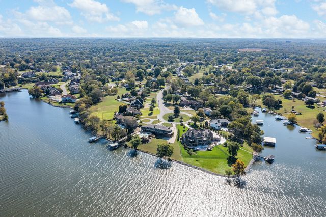 a kitchen with granite countertop a sink a stove and cabinets