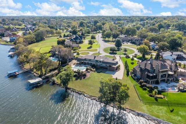 a living room with furniture fireplace and a large window