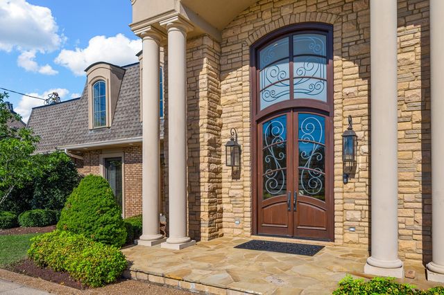 a en suite bathroom with a granite countertop sink and a mirror