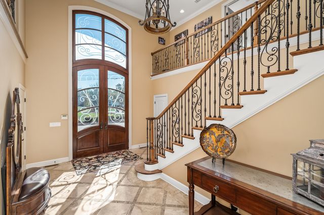 a bedroom with a bed and large windows