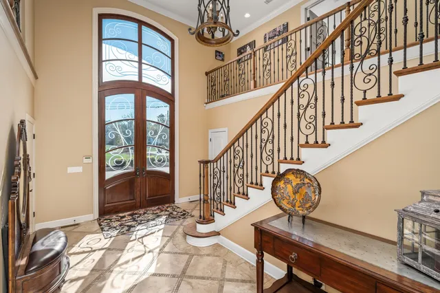 a bedroom with a bed and large windows