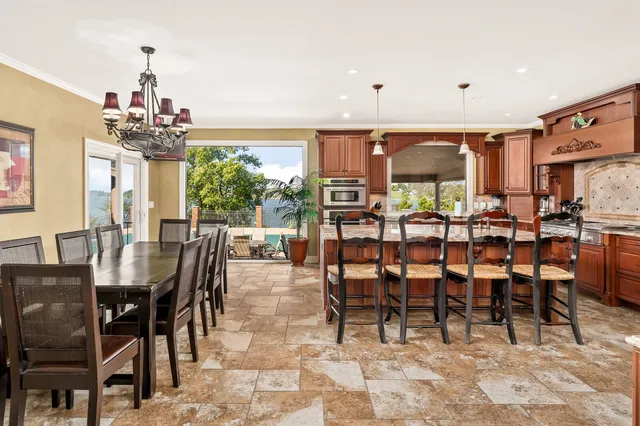 a room with lots of wooden furniture and a large window