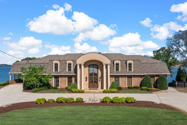 an aerial view of a house with a lake view