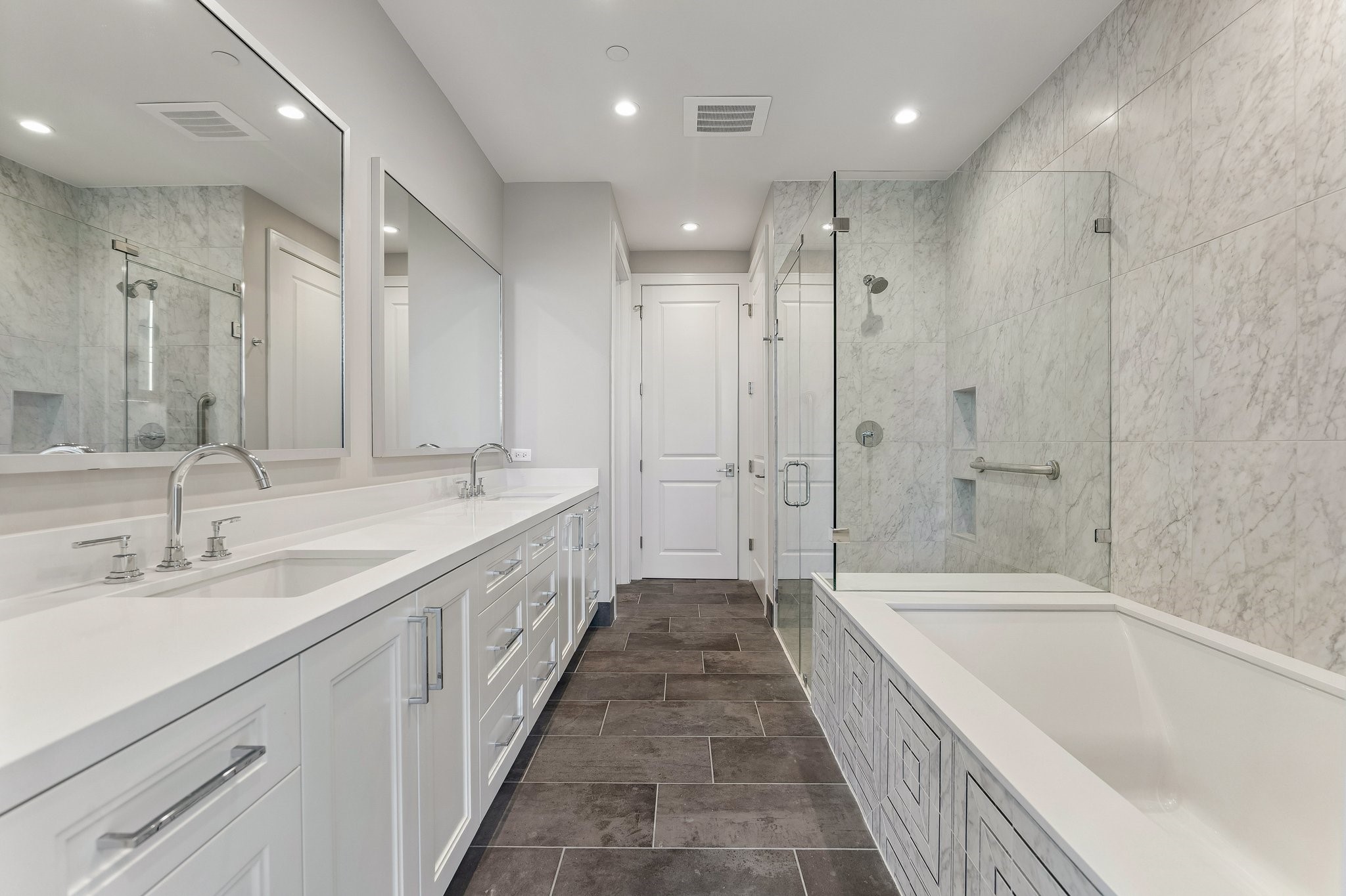 5656 San Felipe Street, Unit 701 Houston, TX 77056 - Photo 18 of 44 Transform your own primary bathroom into an at home-spa. An oasis complete with soaking tub, framed with designers decorative tile, a seamless walk-in glass shower, an expansive double vanities featuring generous counter space, a linen closet and a door leads to a private water-closet.