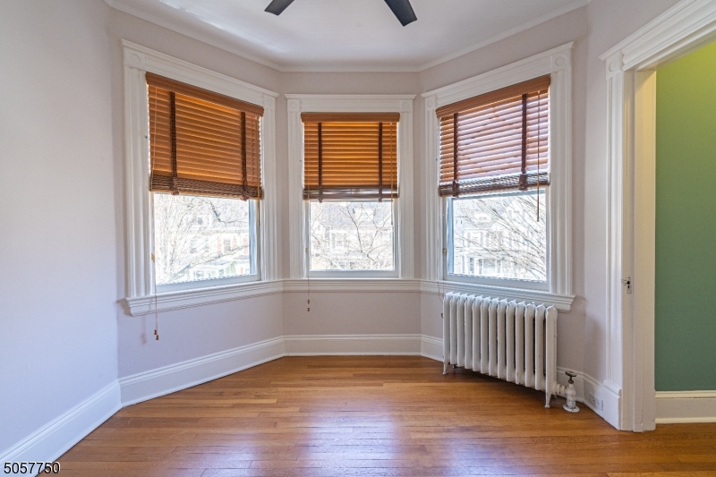 12 Wetmore Avenue, Unit 1 Morristown, NJ 07960 - Photo 13 of 26 a view of an empty room with wooden floor and a window