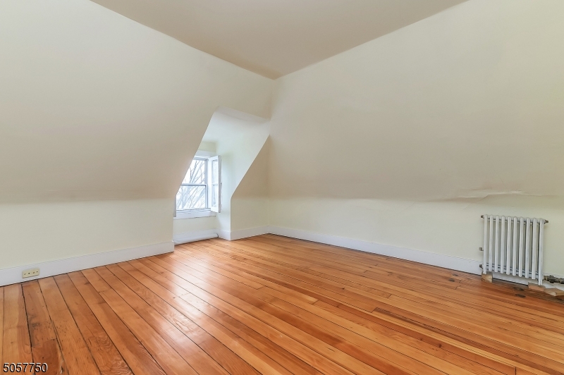 12 Wetmore Avenue, Unit 1 Morristown, NJ 07960 - Photo 17 of 26 an empty room with wooden floor and windows