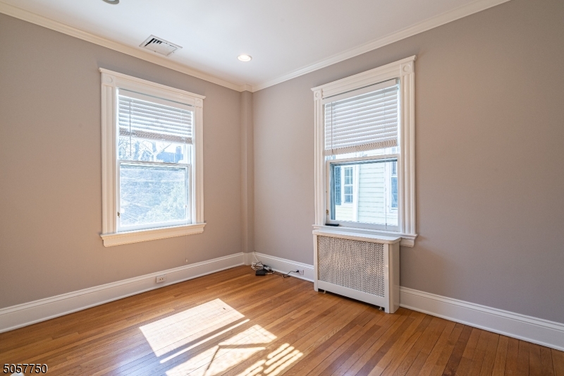 12 Wetmore Avenue, Unit 1 Morristown, NJ 07960 - Photo 25 of 26 a view of an empty room with wooden floor and a window