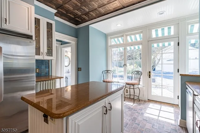 a kitchen with a table chairs and wooden floor