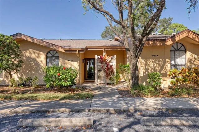 a view of a house with a tree in front