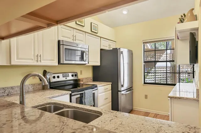 a kitchen with a sink stove and cabinets