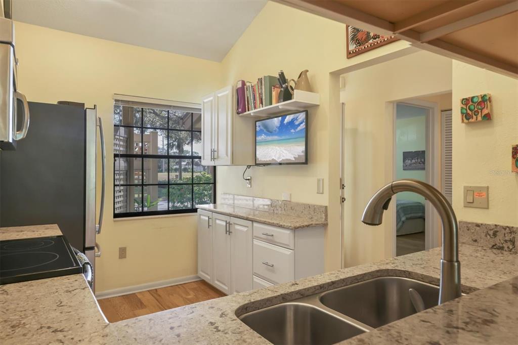 4513 Morningside, Unit 4 Sarasota, FL 34235 - Photo 16 of 81 a kitchen with a sink cabinets and a wooden floor