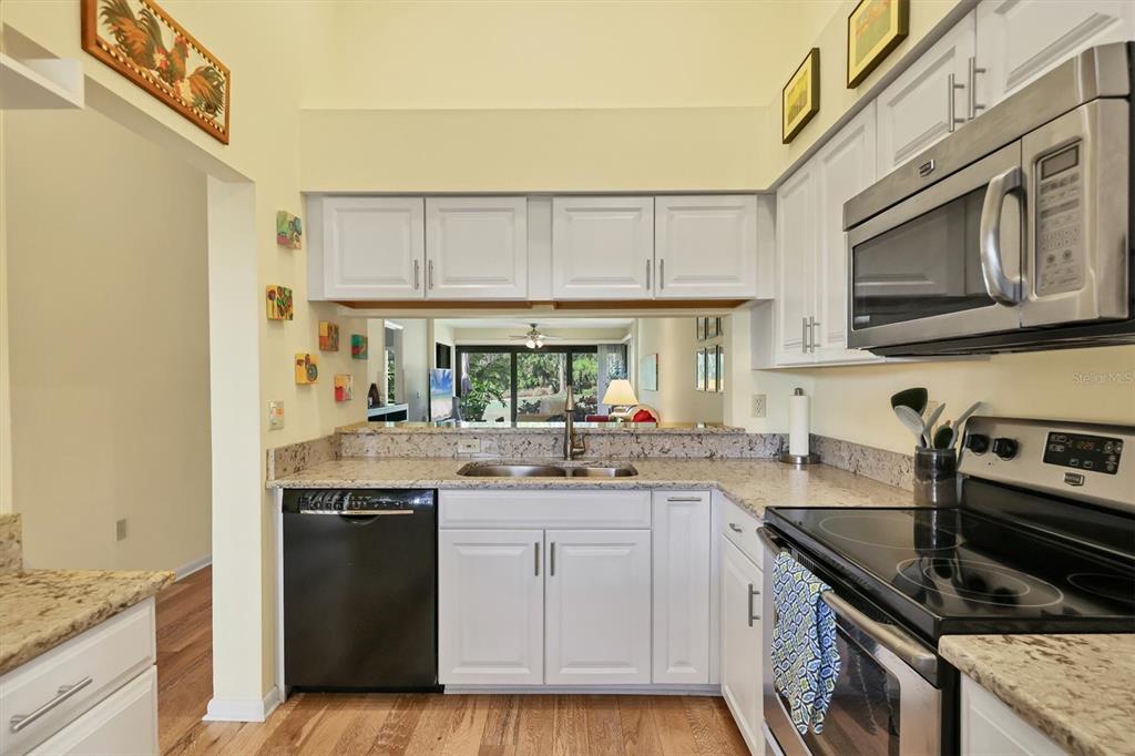 4513 Morningside, Unit 4 Sarasota, FL 34235 - Photo 19 of 81 a kitchen with a sink stove and cabinets
