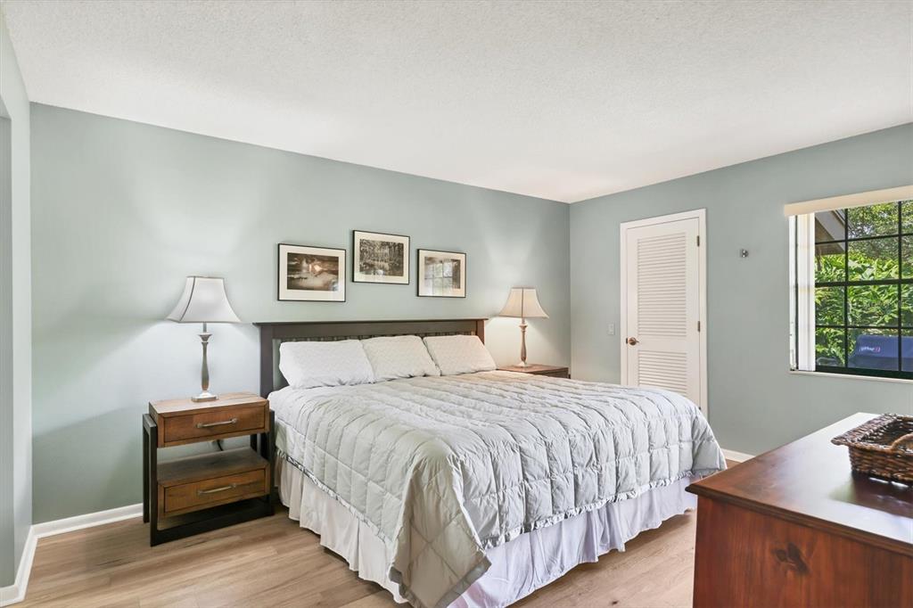 4513 Morningside, Unit 4 Sarasota, FL 34235 - Photo 21 of 81 a bedroom with a bed and a night stand