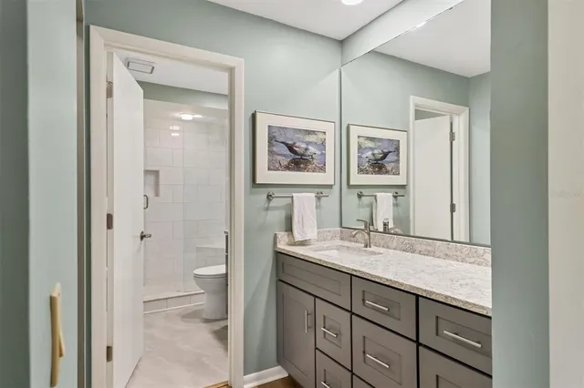 a bedroom with a bed and a computer on a desk