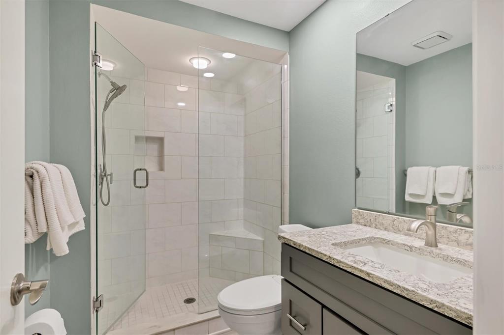 4513 Morningside, Unit 4 Sarasota, FL 34235 - Photo 25 of 81 a bathroom with a granite countertop sink a toilet and shower