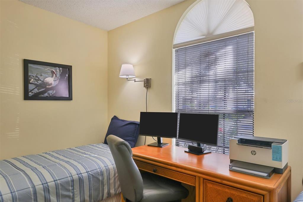 4513 Morningside, Unit 4 Sarasota, FL 34235 - Photo 29 of 81 a bedroom with a bed and a computer on a desk