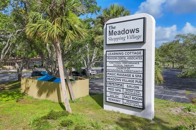 an aerial view of residential house with outdoor space and trees all around