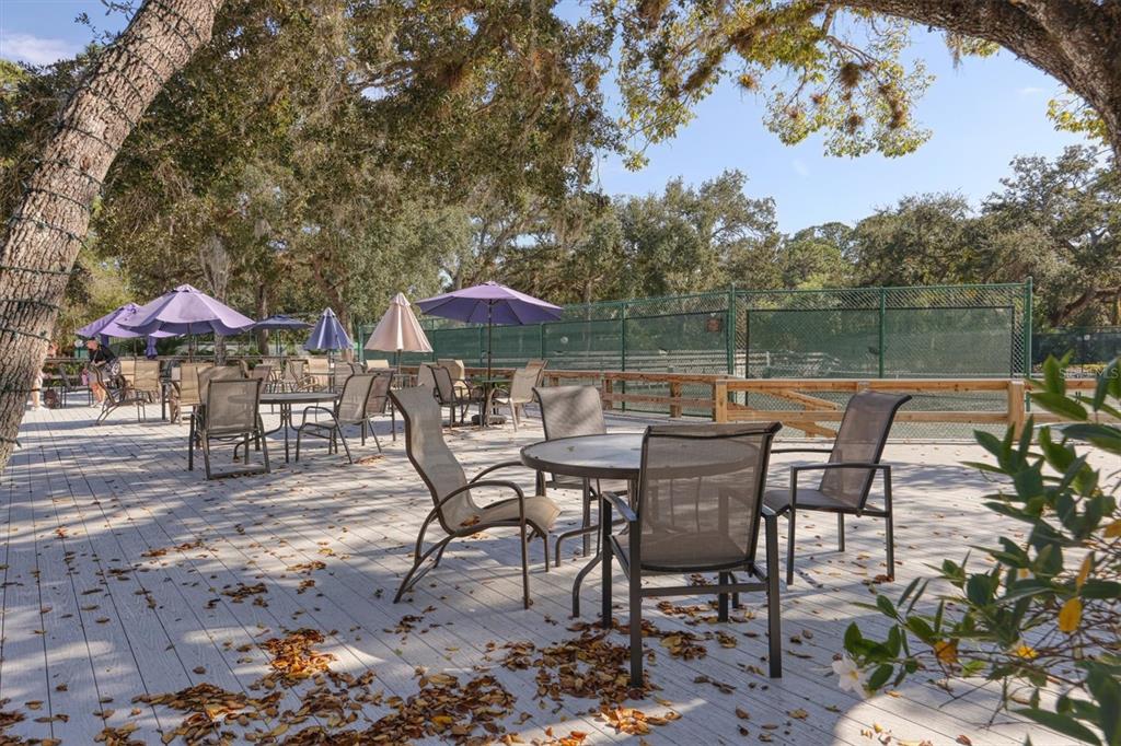 4513 Morningside, Unit 4 Sarasota, FL 34235 - Photo 56 of 81 a view of a chairs and table under an umbrella