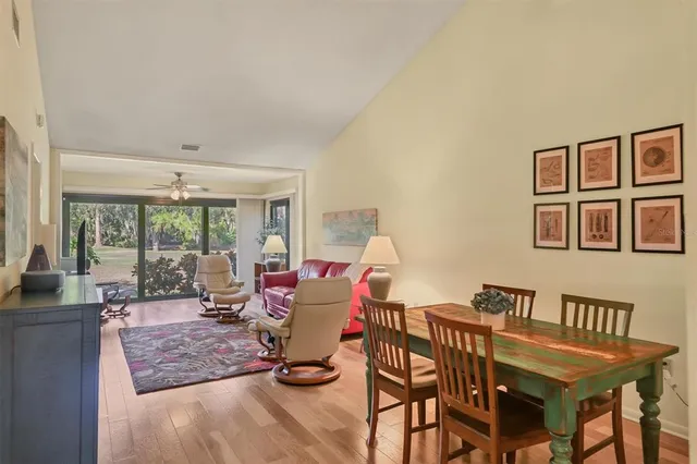 a living room with furniture a wooden floor and a chandelier