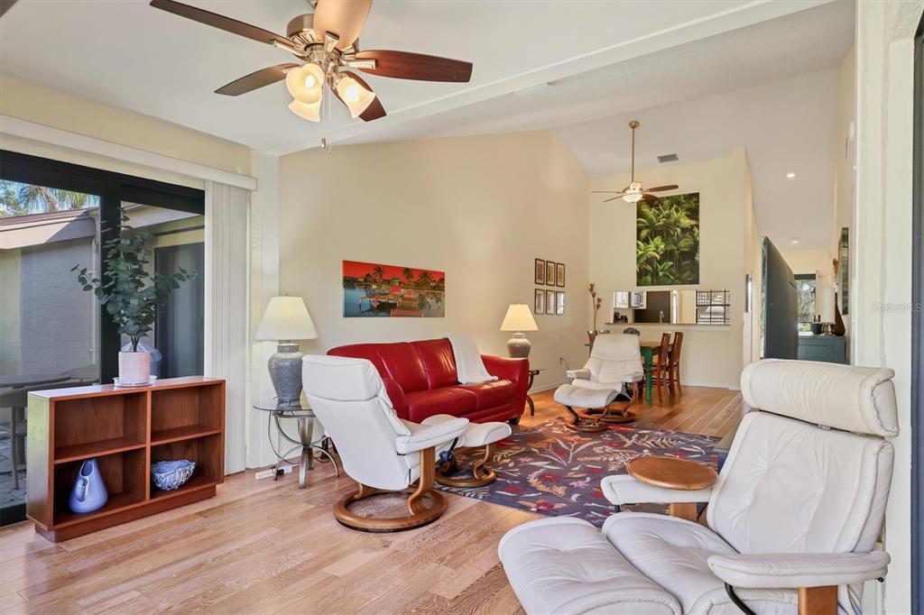 4513 Morningside, Unit 4 Sarasota, FL 34235 - Photo 10 of 81 a living room with furniture a wooden floor and a chandelier