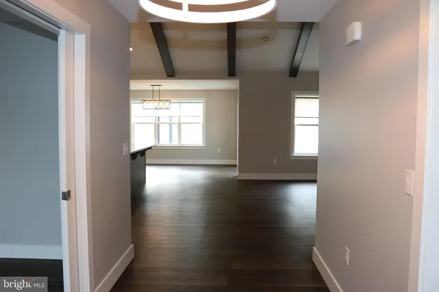 a view of a livingroom with wooden floor and a large window