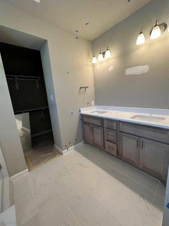 2525 Four Roses Drive Lewisville, TX 75056 - Photo 15 of 19 a view of a double sink and a mirror in a room