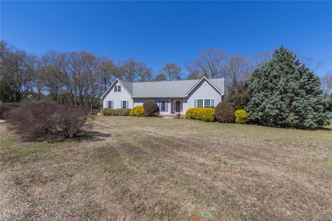 108 Pearman Drive Pendleton, SC 29670 - Photo 2 of 50 This charming home features a classic facade set against a clear blue sky, surrounded by natural landscaping.