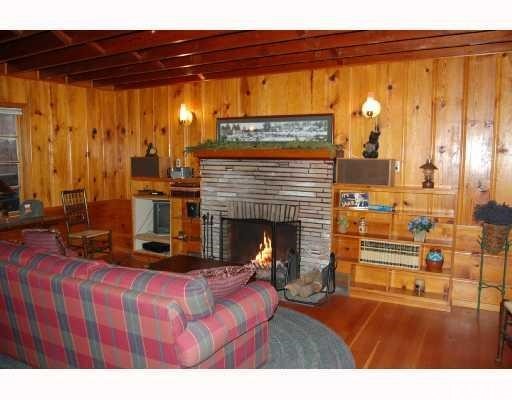 29053 Cedar Terrace Lake Arrowhead, CA 92321 - Photo 3 of 8 a living room with furniture a fireplace and a window