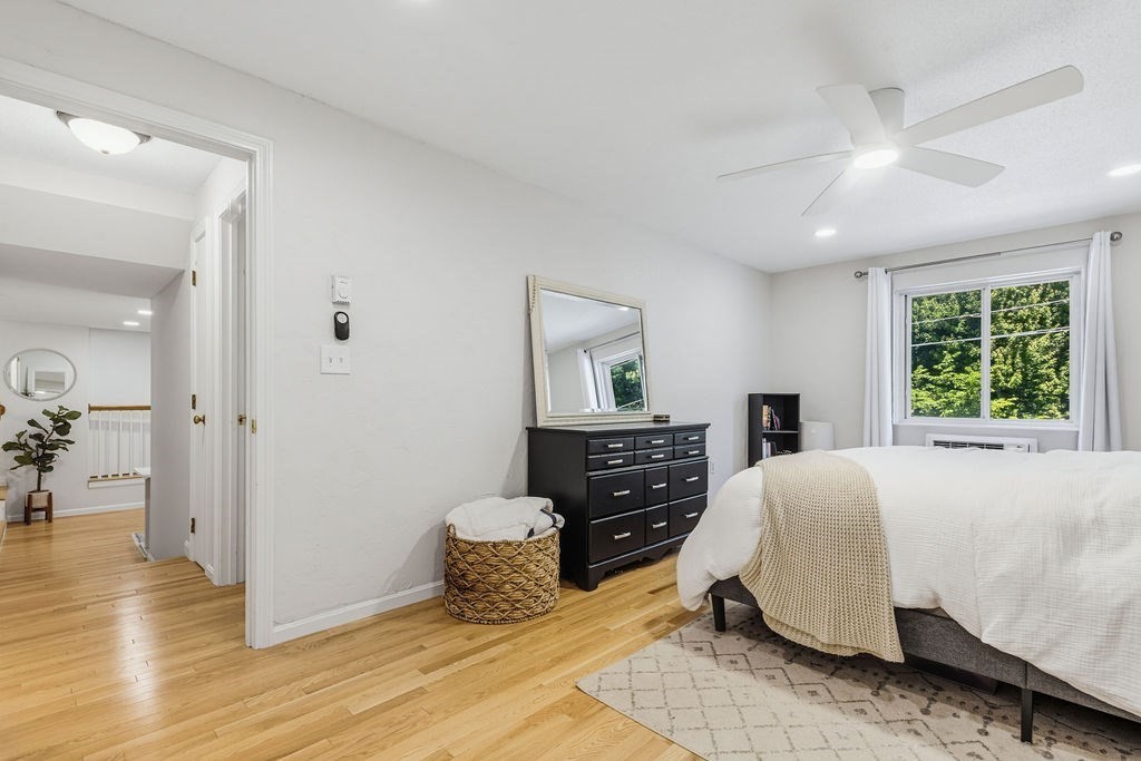10 Erick Road, Unit 42 Mansfield, MA 02048 - Photo 23 of 33 a spacious bedroom with a bed and wooden floor