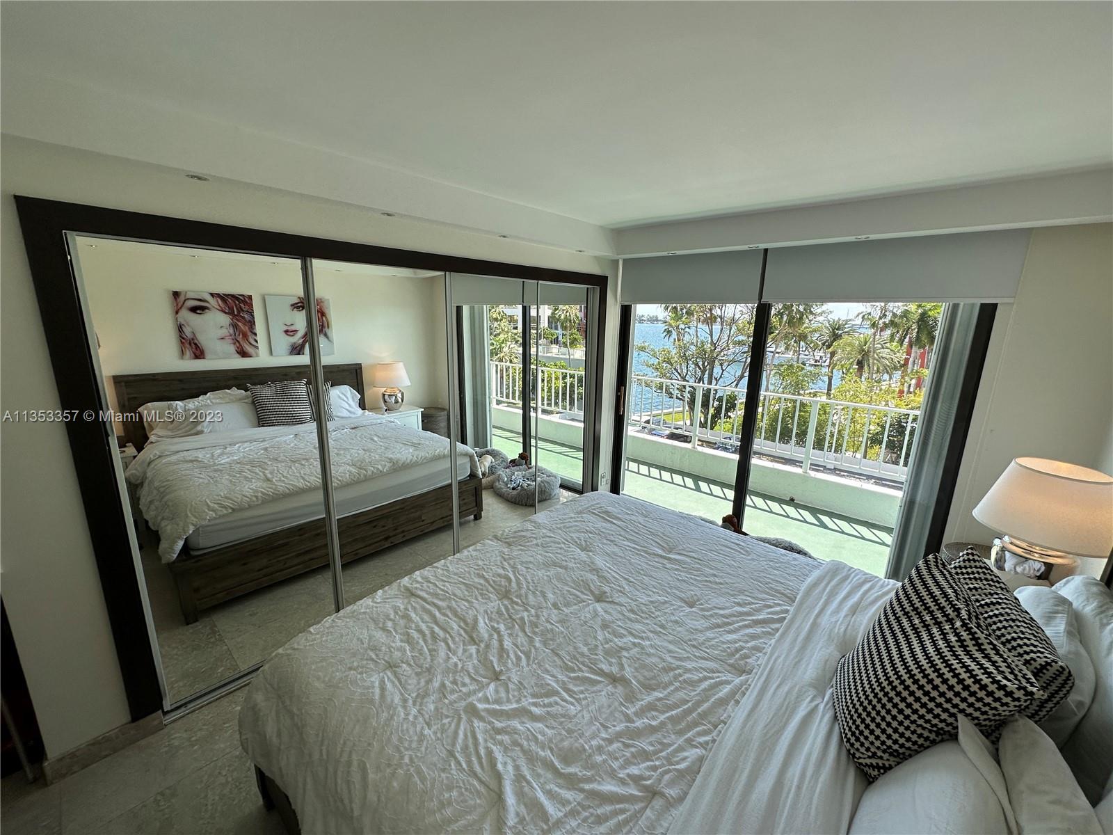 200 Southeast 15th Road, Unit 5J Miami, FL 33129 - Photo 14 of 20 a bedroom with a bed and a large window